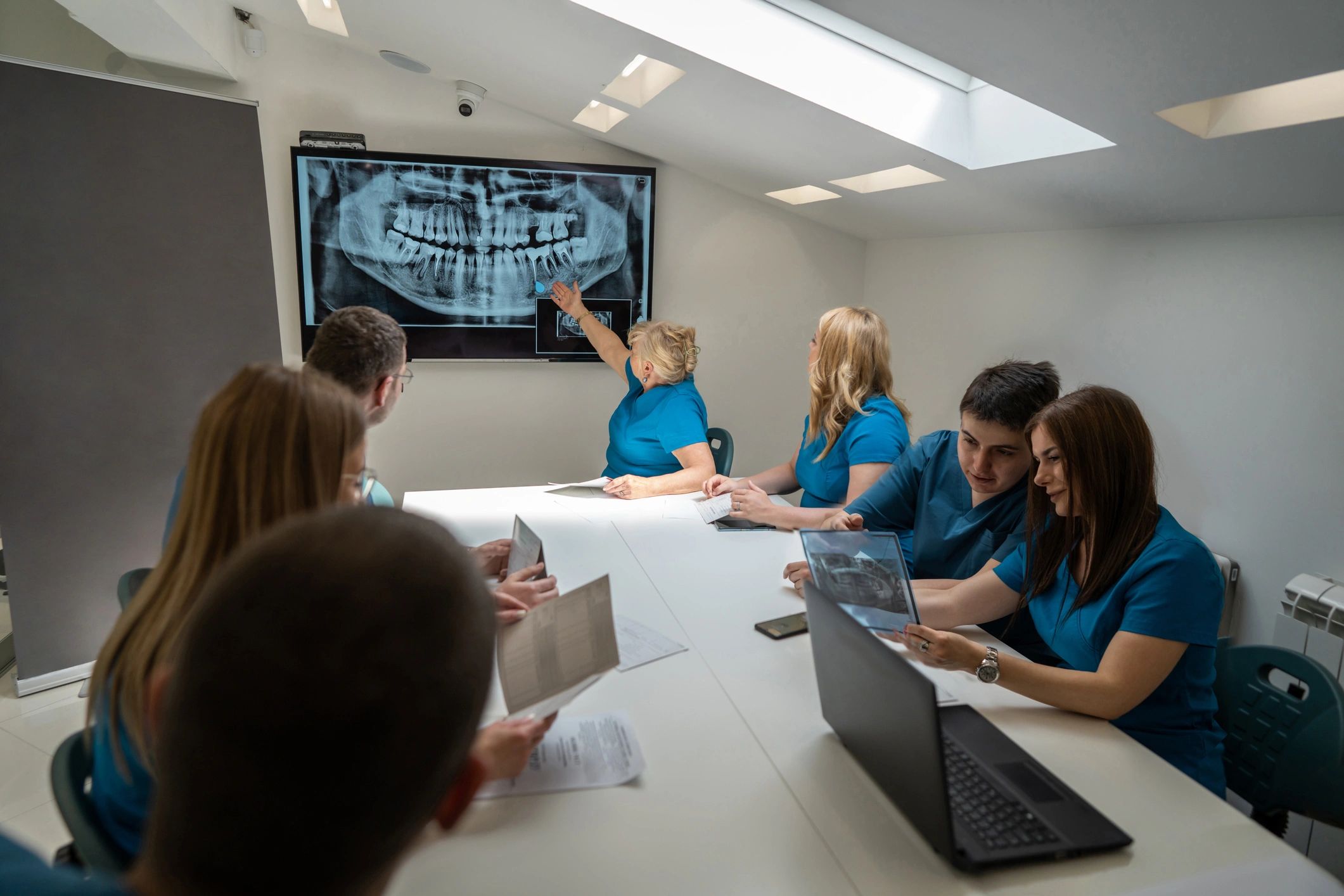Dental team meeting reviewing imaging