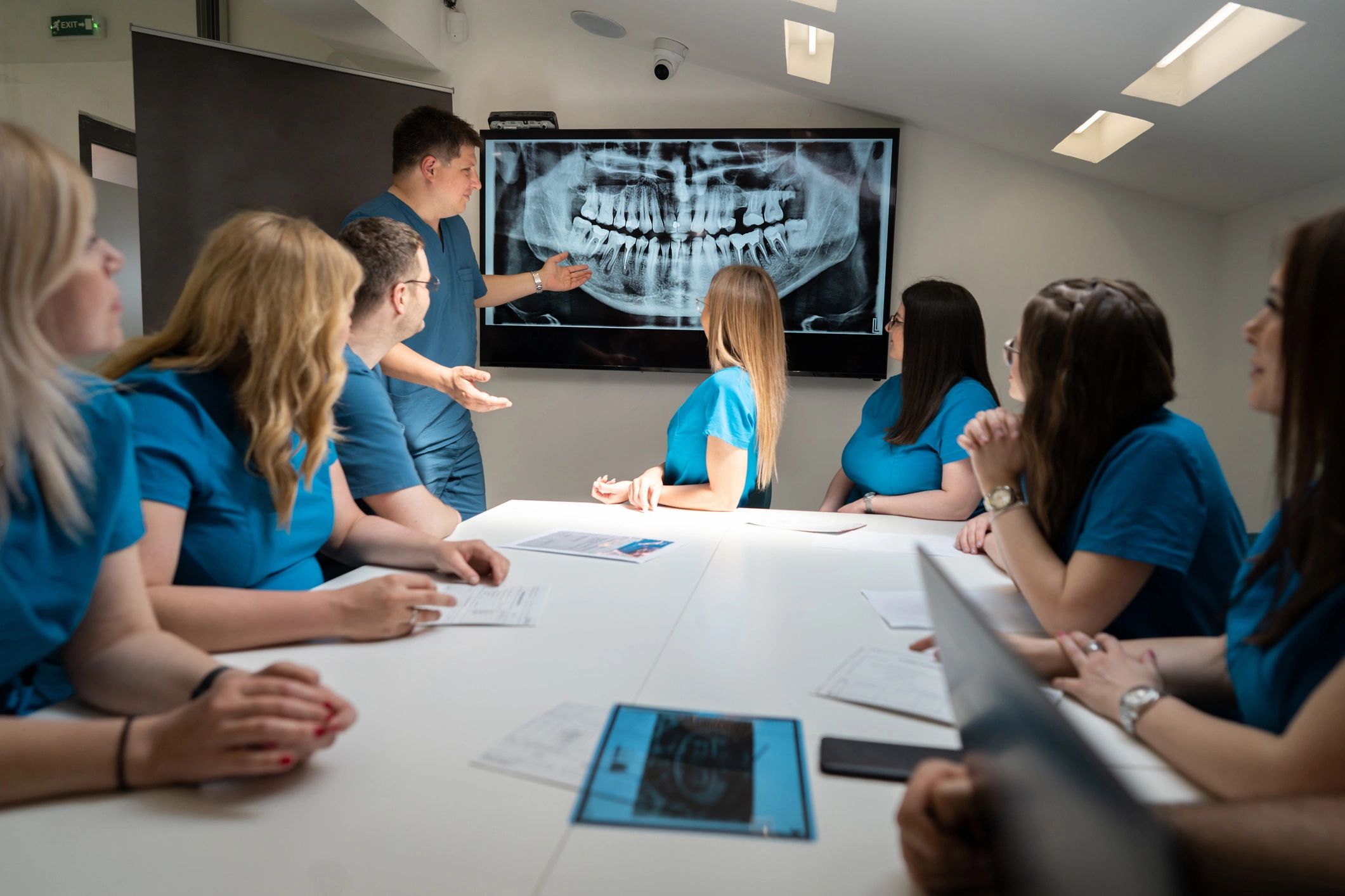 Dental team reviewing radiographs during a case planning discussion