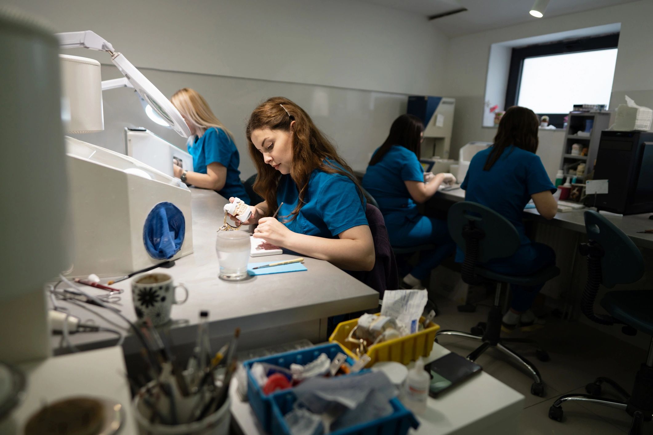 Dental laboratory technician at a workbench