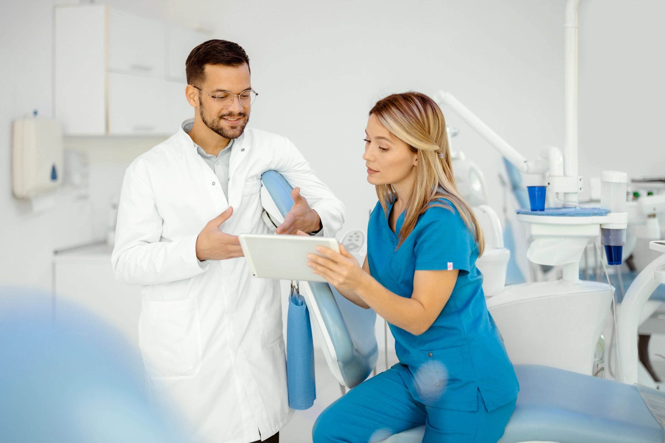 Dental professionals reviewing a case together in a clinic setting