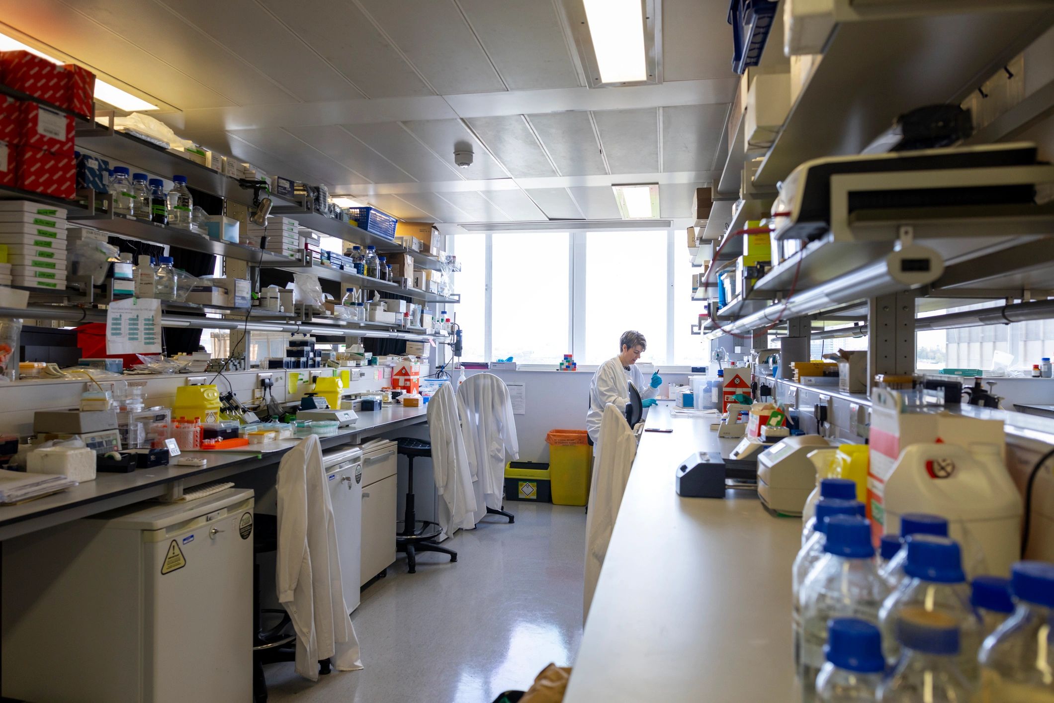Lab professional working at a bench, representing quality control and case review