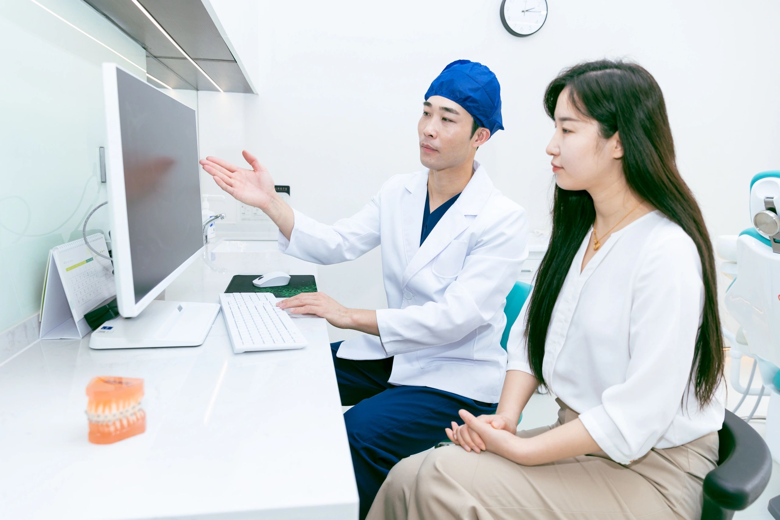 Dental professional speaking with a patient in a clinic
